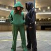 This is an image of two ladies wearing Plain Dark Green Hoodie | Grön Hoodie | Unisex​ and Plain Black Hoodie | Svart Hoodie | Unisex​